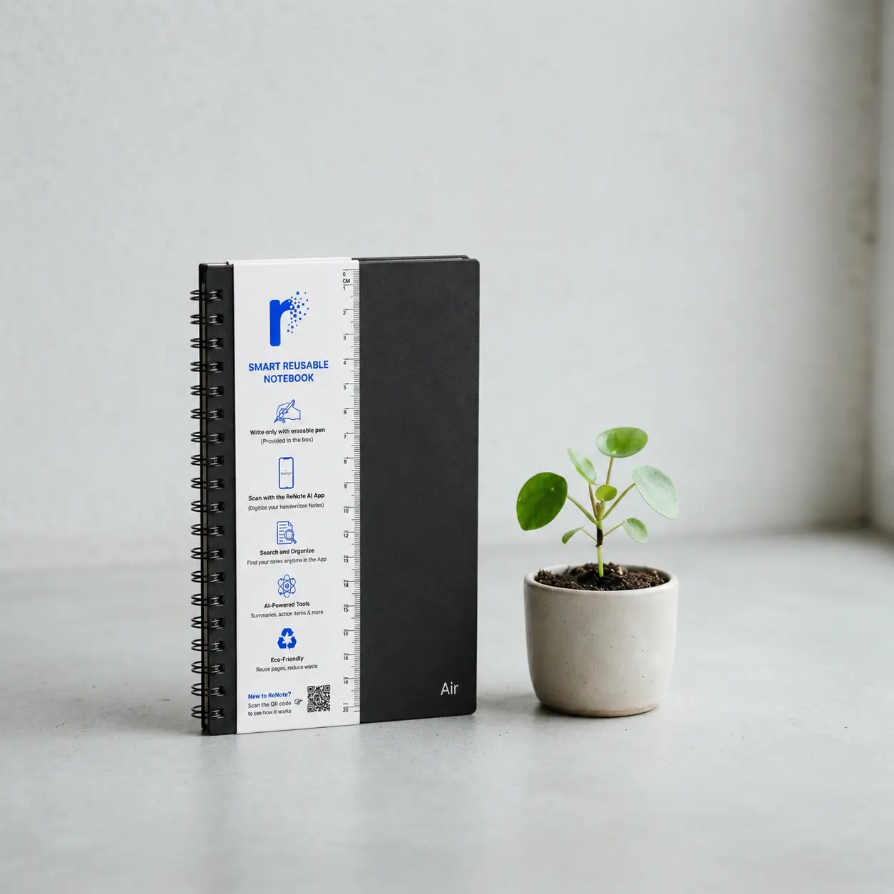 A single rBook notebook beside a small green plant sprout
